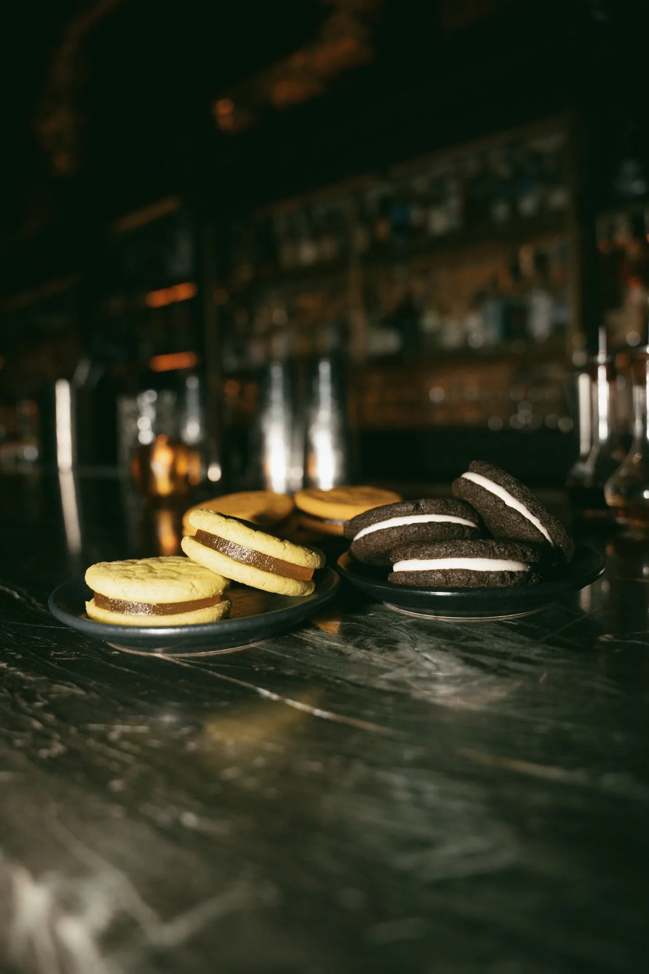 Three plates of cookies showcasing the three conctail-inpired, zero-proof event favors that Royce + Reign offers in their Cookie Flight bundle.
