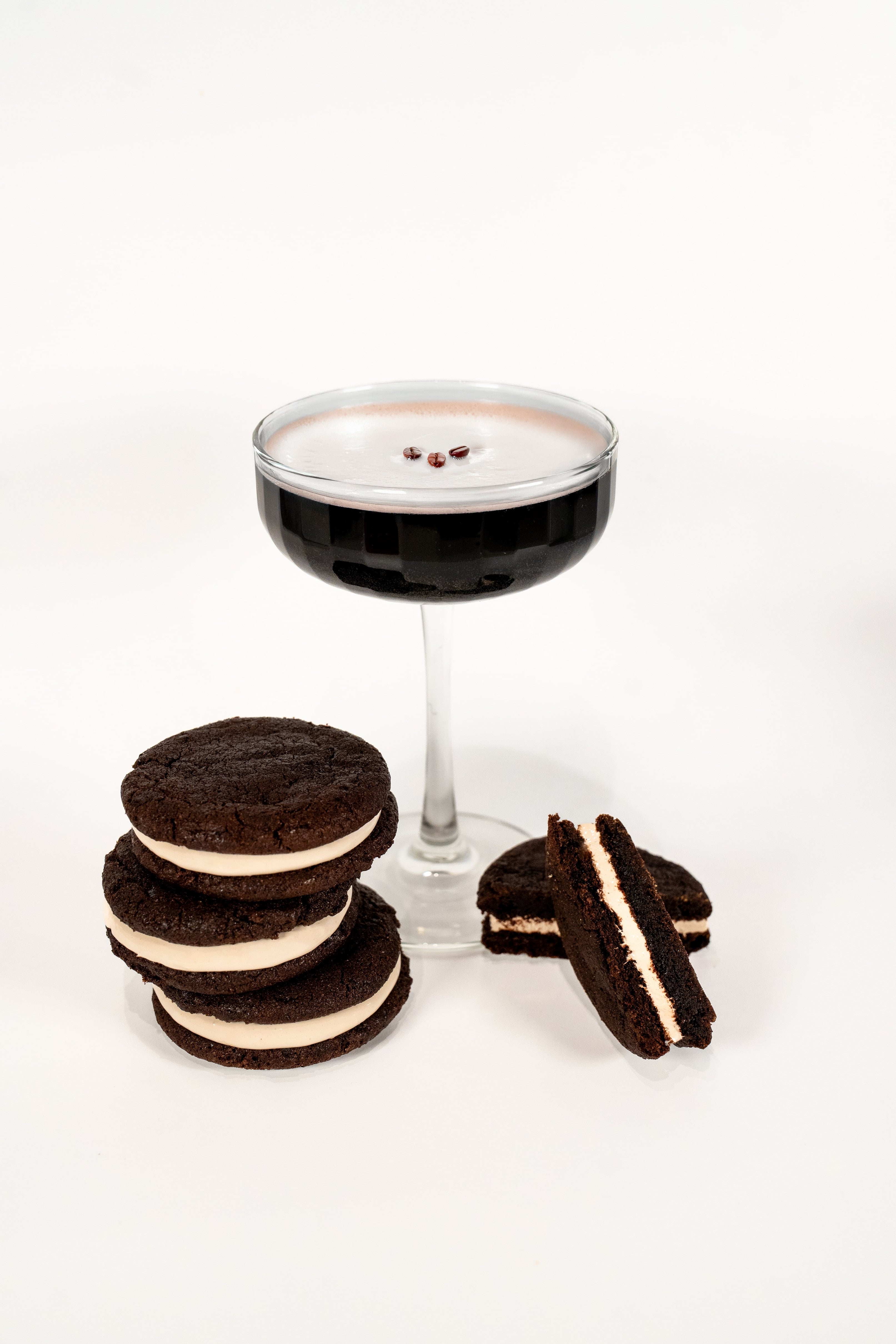 Espresso Martini Cocktail glass next to 4 Royce+Reign zero-proof event favor cookies