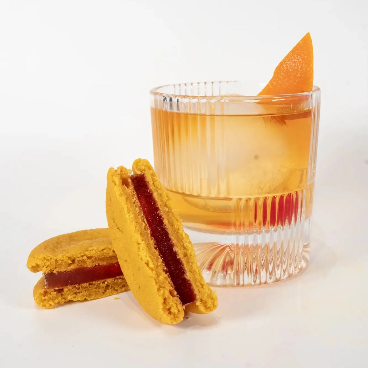 Old Fashioned cookies beside an Old Fashioned with an orange peel